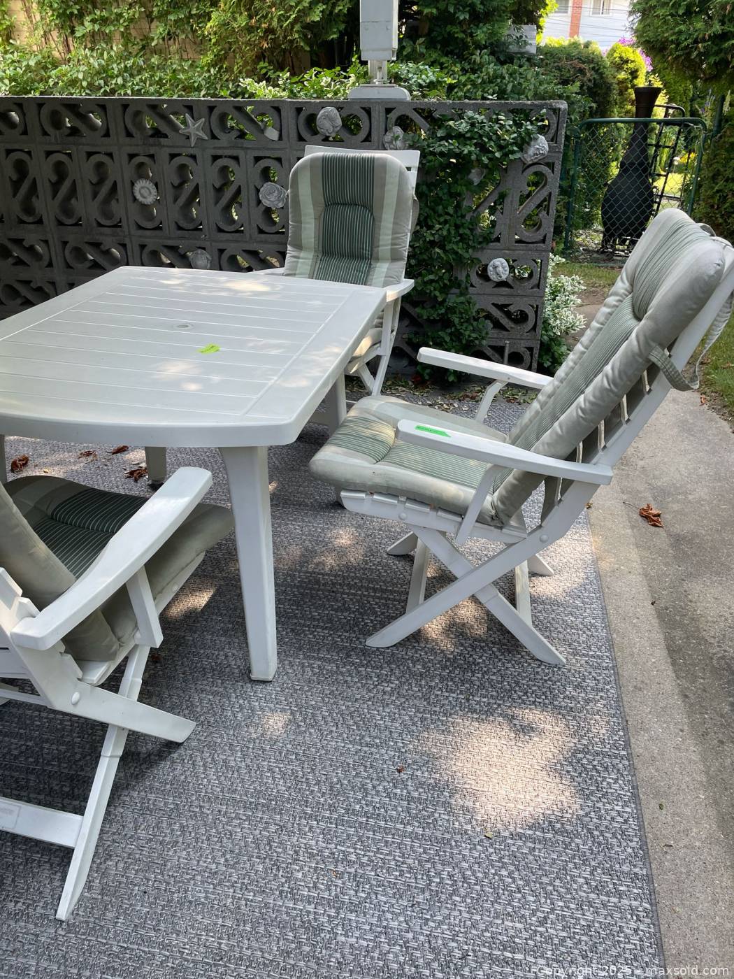 White resin patio table, 4 chairs, side table | Maxsold