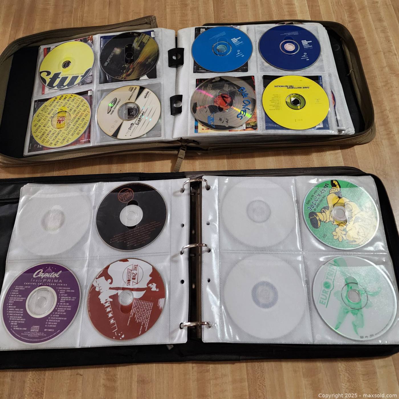 Two CD binders with assorted music CDs | Maxsold