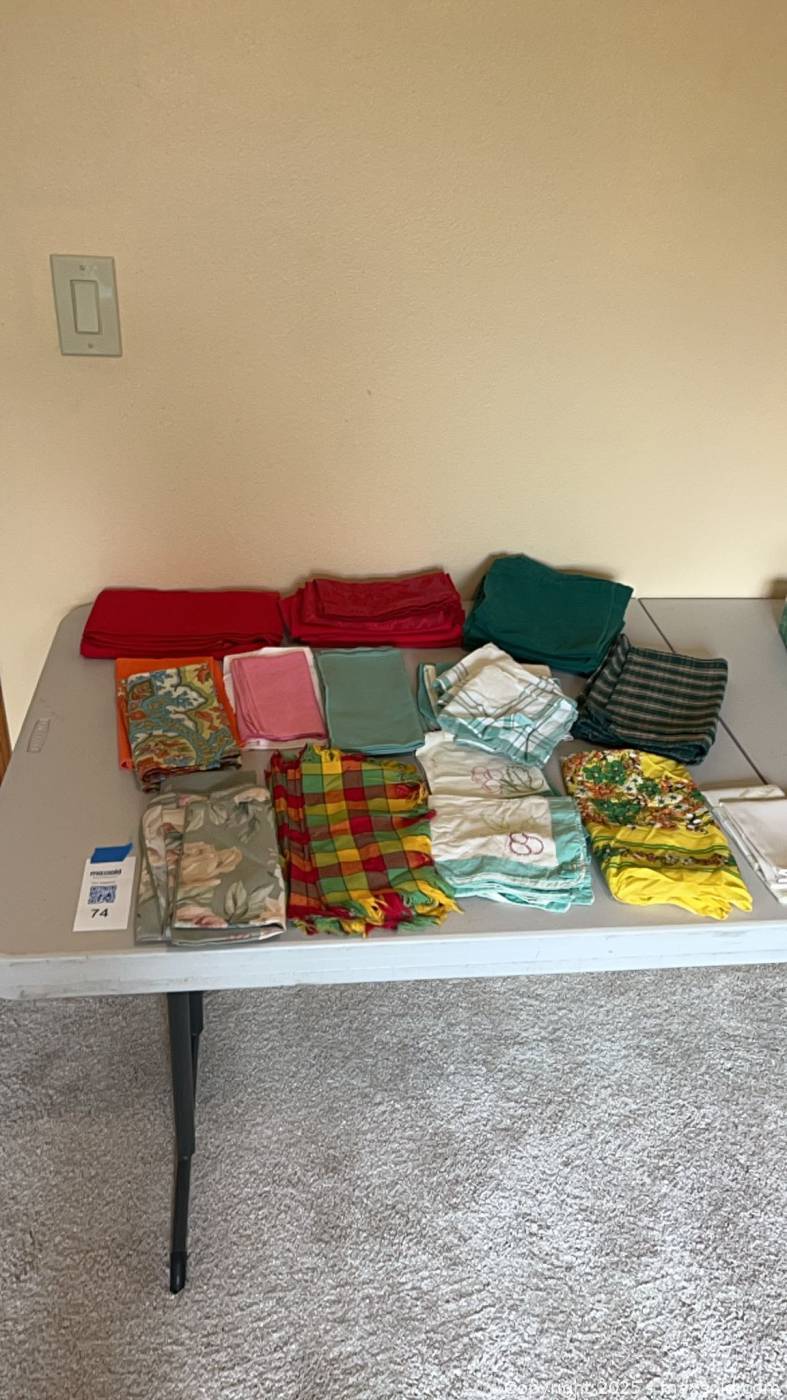 Assorted cloth napkins and red tablecloth | Maxsold