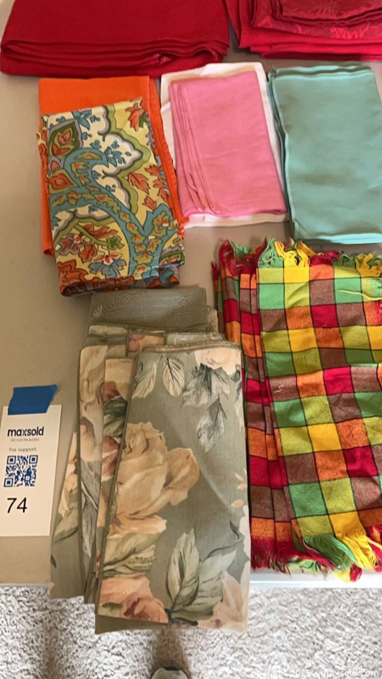 Assorted cloth napkins and red tablecloth | Maxsold