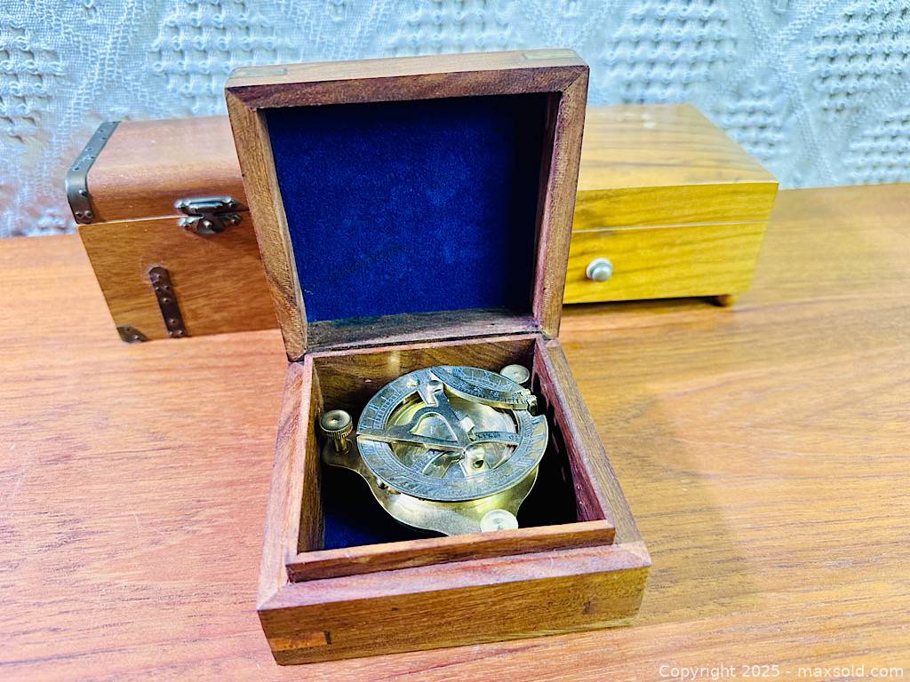 Brass sundial compass with box and two Swiss wooden music boxes | Maxsold