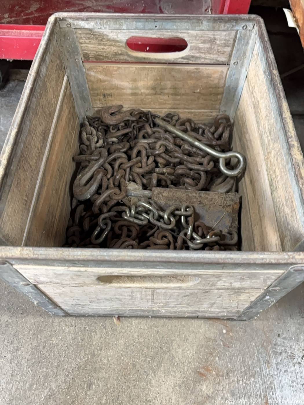 Mixed steel chains, hooks and eye bolt in wood crate | Maxsold