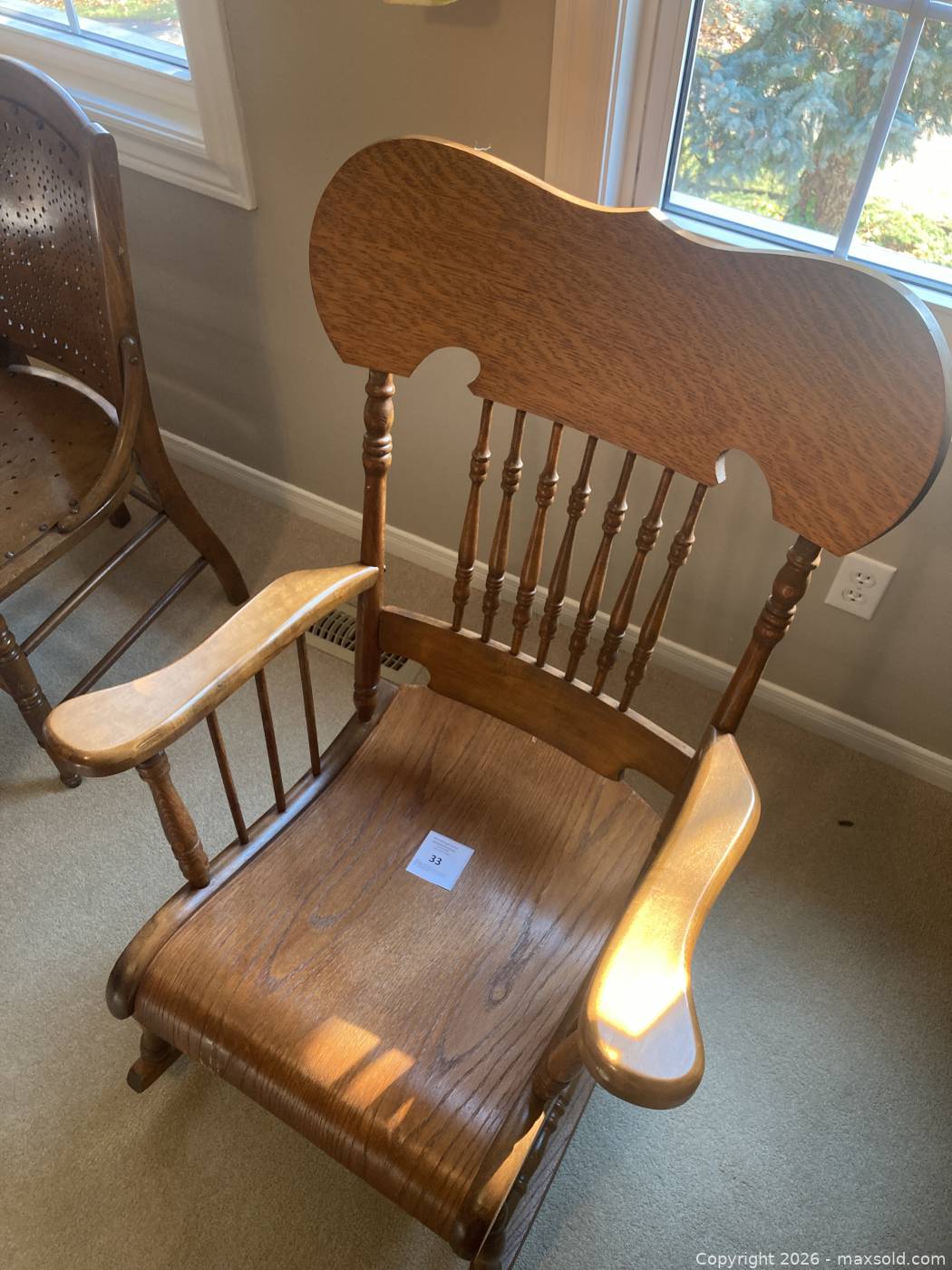 Vintage pressed-back oak rocking chair | Maxsold