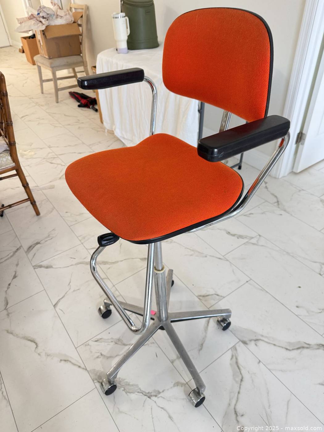 Orange upholstered drafting swivel chair | Maxsold