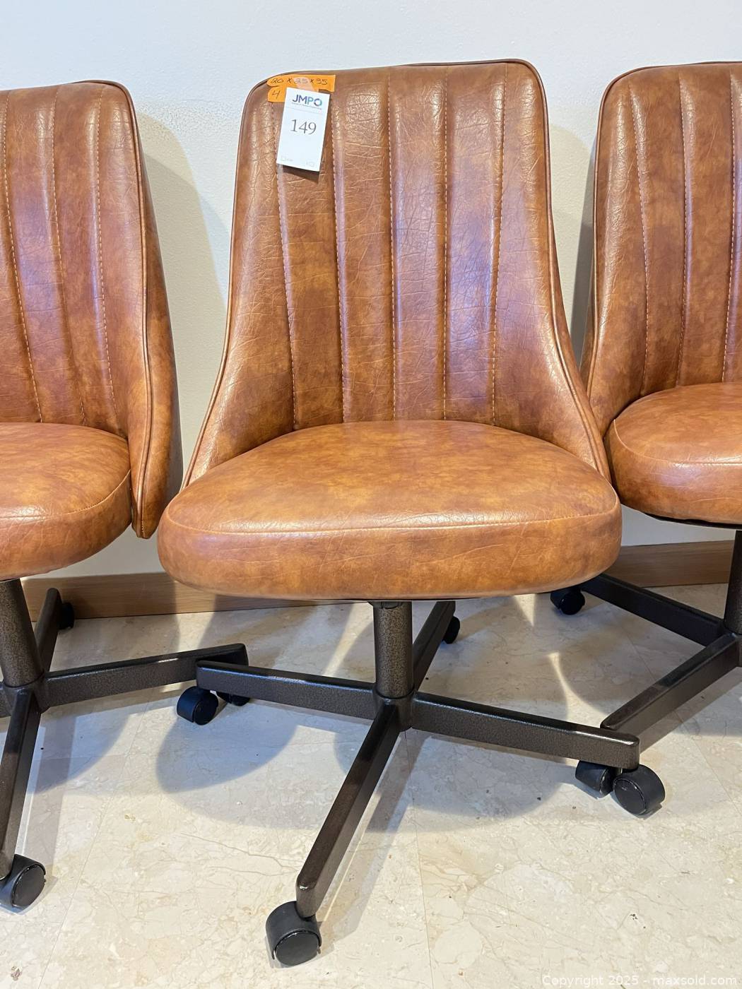 Set of four mocha vinyl rolling chairs | Maxsold