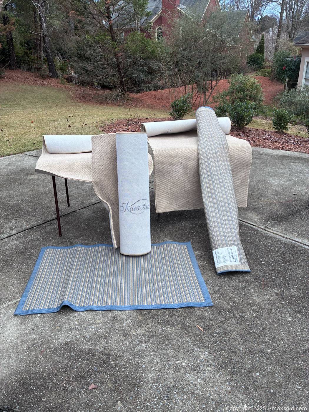 Two Crate & Barrel rugs with carpet remnants | Maxsold