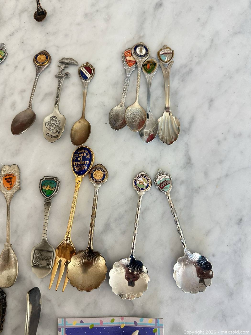 Approximately 49 souvenir spoons and small forks | Maxsold
