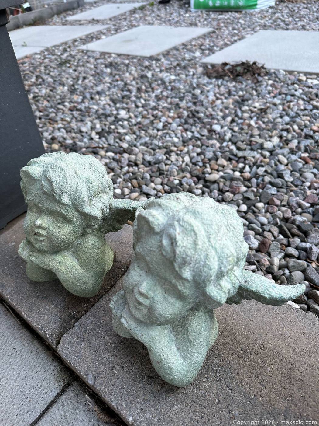 Concrete cherub head statues | Maxsold