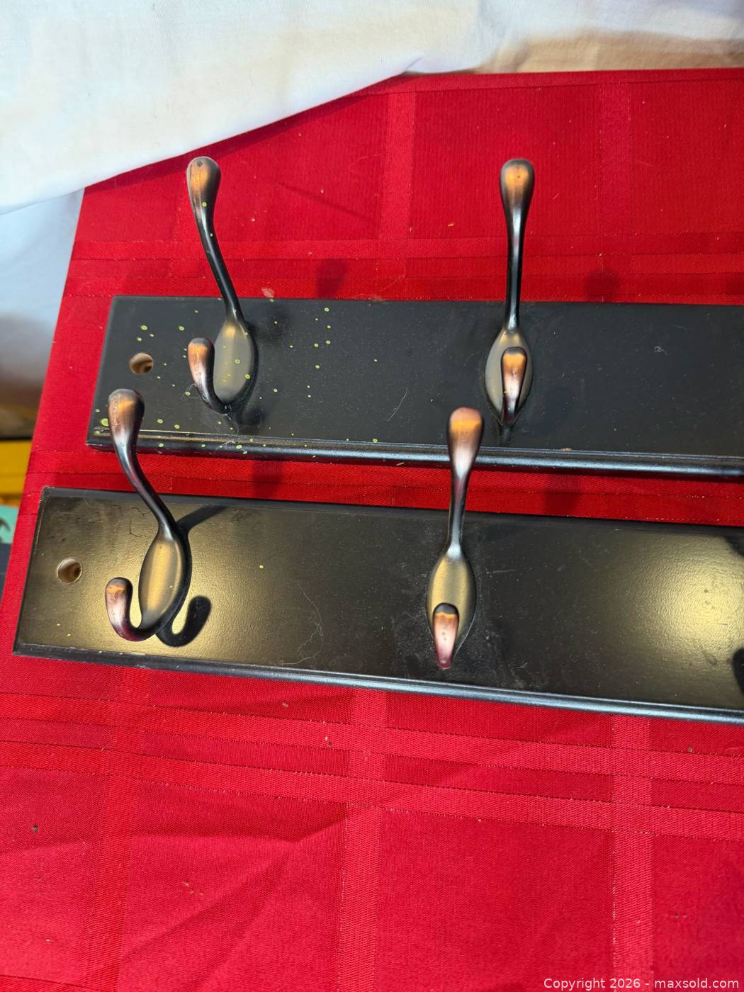 Two dark wood wall-mount coat racks with six metal double hooks each ...